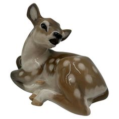 a deer figurine sitting on top of a white surface