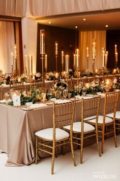 a long table is set up with gold chairs and white linens for an elegant wedding reception