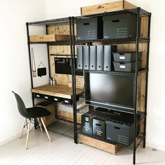 a room with some shelves filled with lots of boxes and bins next to a chair