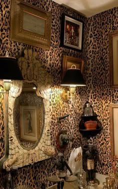 a bathroom with leopard print wallpaper and two lamps