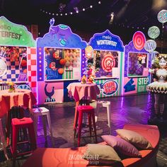 the stage is set up for an event with colorful booths and decorations on each side