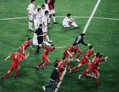 a group of men playing soccer on a field