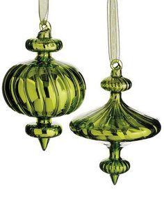 two green glass ornaments hanging from strings