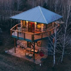 an aerial view of a house in the woods