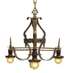 an antique chandelier with three lights hanging from it