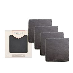 four black slate coasters in a box