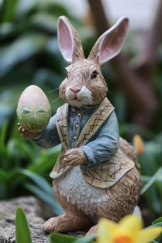 a statue of a rabbit holding an easter egg