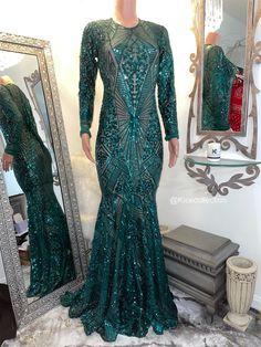 The Emmy gown is a emerald green sequins gown in a size S/M with some stretch. Bust 31”-38”, Waist 30”-38”, hips 37”-44”. L/sleeve 22”. Shoulder to knee 33”. L/train front 30”, back 38”. Fitted Green Sequin Evening Dress, Fitted Full-length Sequin Maxi Dress, Green Fitted Long Sleeve Evening Dress, Full Length Sequined Gown For Night Out, Green Long Sleeve Gown With Sequins, Green Long Sleeve Party Gown, Glamorous Embellished Green Maxi Dress, Fitted Long Sleeve Gown With Contrast Sequin, Green Long Sleeve Evening Dress For Party Season