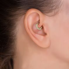 "Minimalist with a modern chic design, this 14k gold diamond daith hoop is perfect for everyday wear. Materials: * 14K Solid Gold (Weight: 1.25g) - Available in yellow, rose or white gold. * Genuine White Diamonds (Weight: 0.11ct VS-SI/G-H) Measurements: Wire thickness: 18g - 1mm Inner diameter of the ring: 0.3\" - 8mm Outer diameter: 0.55\" - 14mm Number of diamonds: 11 Diamond size: 1.3mm * Nickel free and hypoallergenic Fits: septum, tragus, daith, conch and helix. Please note: This design is Daith Ring, Daith Hoop, Daith Earring, Daith Rings, Tragus Daith, Daith Jewelry, Daith Piercing Jewelry, Daith Earrings, Geometric Hoop Earrings