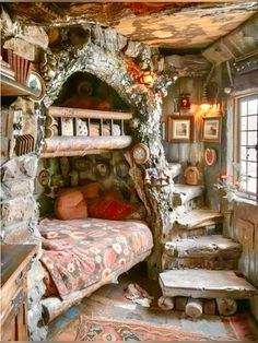 a bed room with a stone wall and lots of stuff on the floor next to it