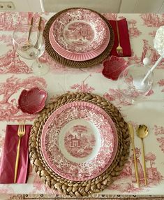 the table is set with pink and white china