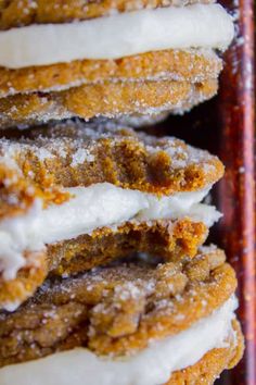 several doughnuts with icing and powdered sugar on them