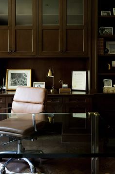 an office with a desk, chair and bookcase
