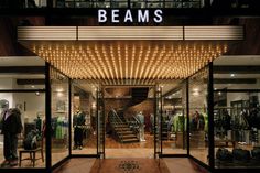 the entrance to beams clothing store at night