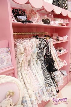 a pink shelf filled with lots of clothes