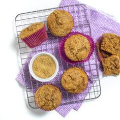 several muffins on a cooling rack next to a cup of coffee