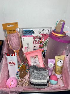 the contents of a woman's gift basket are neatly organized