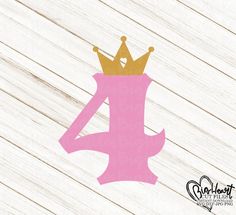 a pink and gold number four with a crown on it's head sitting on top of a wooden floor