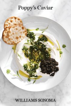 the cover of poppy's caviar by william sonomaa is shown on a plate with crackers