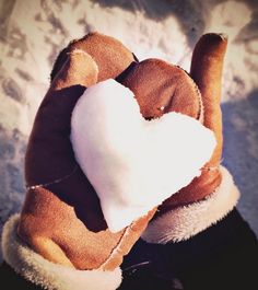 a person wearing a glove with a heart on it