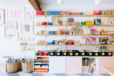 there are many books and craft supplies on the shelves in this room that is filled with toys