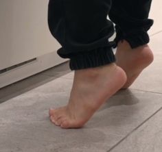 a person standing on the floor with their bare feet