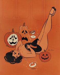 a woman laying on the ground surrounded by pumpkins and jack - o'- lanterns