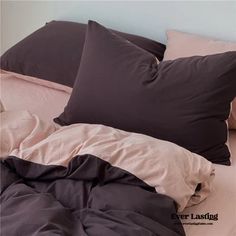 a bed with pillows and blankets on top of it