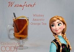 there is a doll next to a glass of orange tea