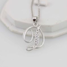 "Beautiful Initial Necklaces Solid Sterling Silver, perfect for anyone any age any occasions and everyday wear Great gift for that special someone or yourself. Item Specifications: Model # Letter D Metal Type: Sterling Silver Metal Stamp: 925 Shape: Letter D Finish: Rhodium-plated Style: Script Letter Size: 3/4 x 5/8 inch (approx 18 x 15mm) Stone: Multi CZ Stone Chain: Sterling Silver Round Cable Chain 18\" * We only sell SOLID metals Stamp: 925 Sterling Silver. We do NOT Silver plate our Jewelr Silver Cubic Zirconia Initial Necklace For Gift, Silver Initial Necklace With Clavicle Chain For Anniversary, Letter D Necklace, A Initial Necklace, D Necklace, Accesorios Aesthetic, D Letter, Sterling Silver Initial Necklace, Silver Initial Necklace