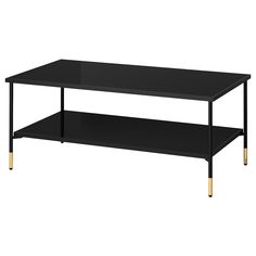 a black coffee table with gold legs