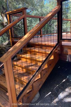 a wooden deck with metal railing and handrails