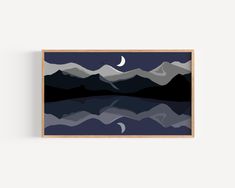 a painting with mountains in the background and a crescent moon above it, hanging on a wall