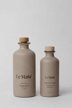 two bottles sitting side by side on a white surface