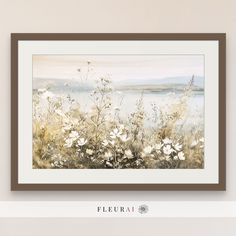 a painting hanging on the wall next to a vase with flowers and water in it