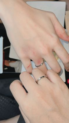 two people with wedding rings on their fingers