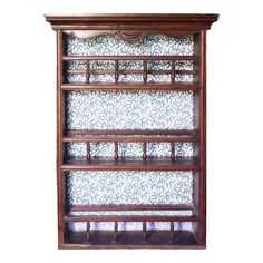 an old wooden book shelf with blue and white tiles on it