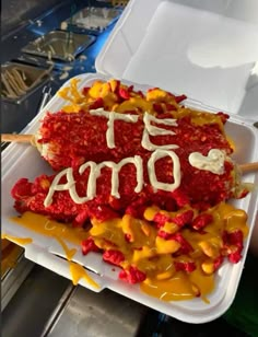 a plastic container filled with food covered in orange and yellow toppings that says oma