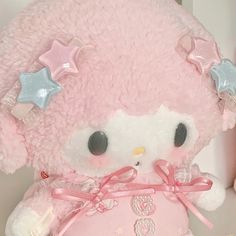 a pink hello kitty stuffed animal with stars on its head