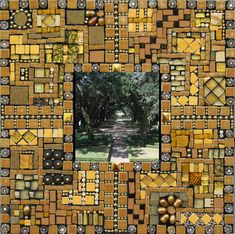 a mosaic photo frame with an image of a path through the woods in yellow and brown