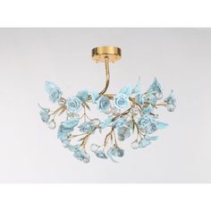 a chandelier with blue flowers hanging from it's sides and two lights on each side