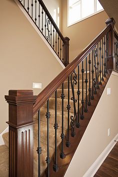 the stairs in this house are made of wood and wrought iron