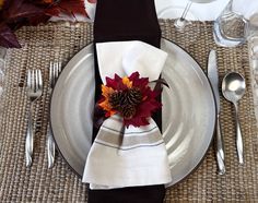 a place setting with silverware and napkins