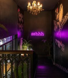 the stairs are lit up with purple lights and flowers on them, along with a chandelier