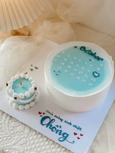 a birthday cake on a table with a candle in the middle and congratulations card next to it