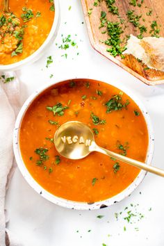 two bowls of soup with a spoon in one