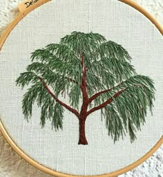 the embroidery pattern shows a large tree with green leaves