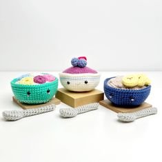 three crocheted bowls are sitting on wooden blocks