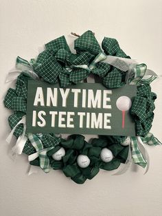 a wreath that says anytime is tee time with golf balls in the middle on it