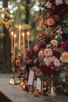 a table with candles and flowers on it